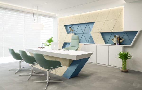 Modern office interior design for Lexus Ceramic in Morbi by Artilett, featuring a geometric wall with beige and blue triangular patterns, a sleek angular desk, teal chairs, and vibrant greenery accents.