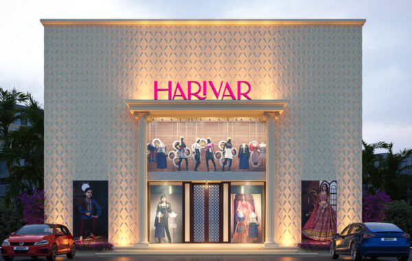 Exterior of ARTILETT-designed retail showroom at dusk, featuring textured facade panels, classical portico entrance, illuminated pink 'HARIVAR' sign, and large display windows with mannequins.